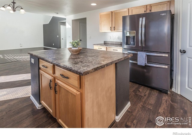 kitchen with stainless steel fridge with ice dispenser, an inviting chandelier, dark hardwood / wood-style floors, hanging light fixtures, and a center island