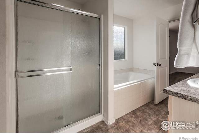 bathroom with vanity and independent shower and bath