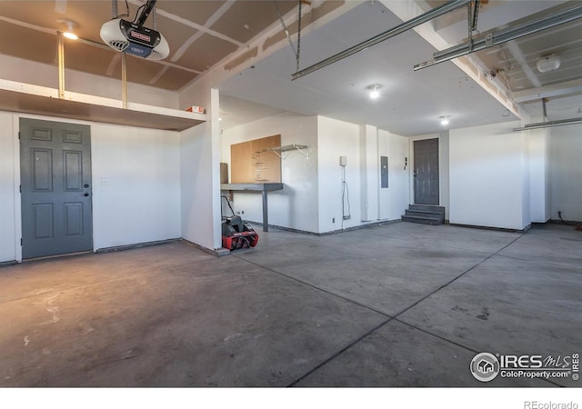 garage with electric panel and a garage door opener