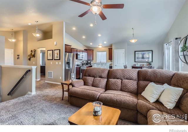 living room with ceiling fan, lofted ceiling, and carpet floors