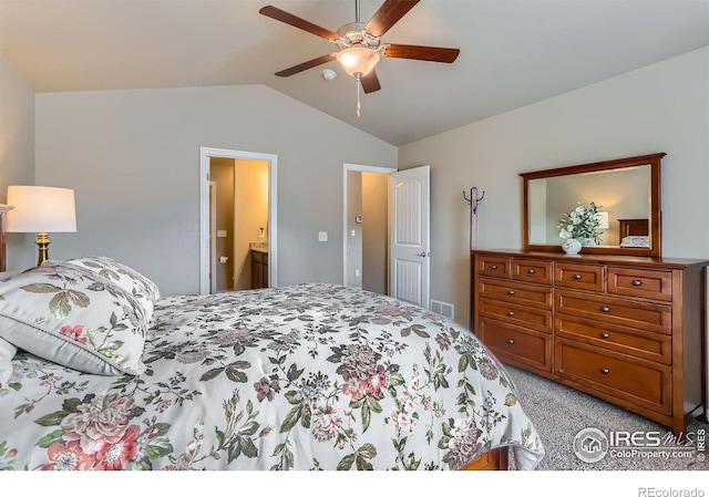 bedroom featuring ensuite bathroom, lofted ceiling, light carpet, and ceiling fan