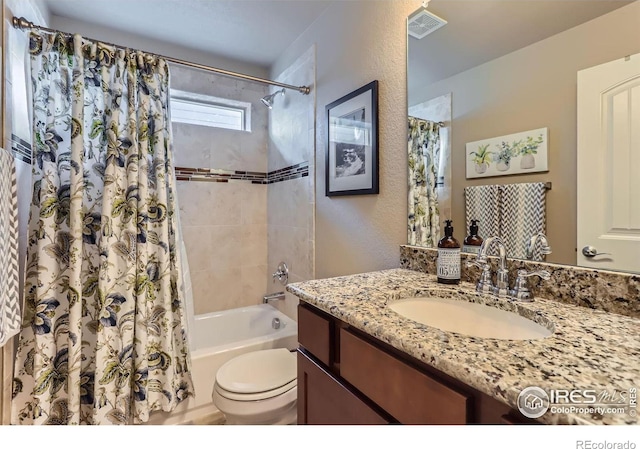 full bathroom featuring vanity, shower / bath combination with curtain, and toilet