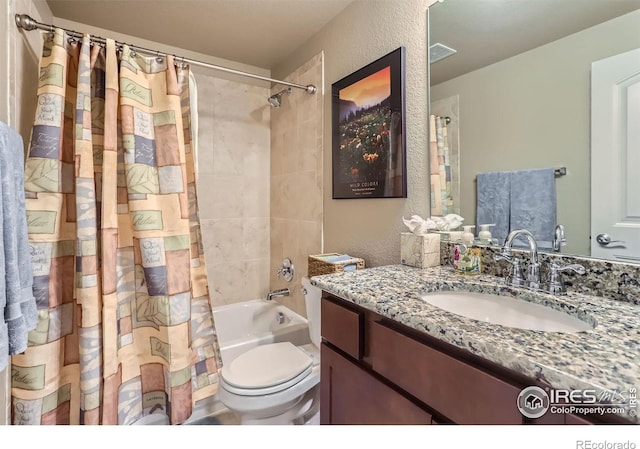 full bathroom with shower / tub combo with curtain, vanity, and toilet