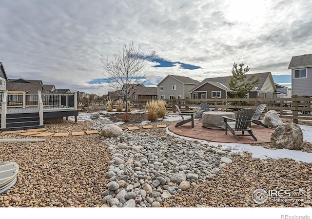 view of yard featuring a patio area, a deck, and an outdoor fire pit