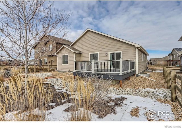 snow covered property featuring a deck