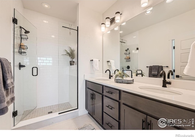 bathroom with tile patterned flooring, vanity, and a shower with shower door