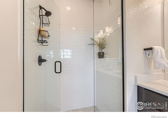 bathroom with vanity and an enclosed shower