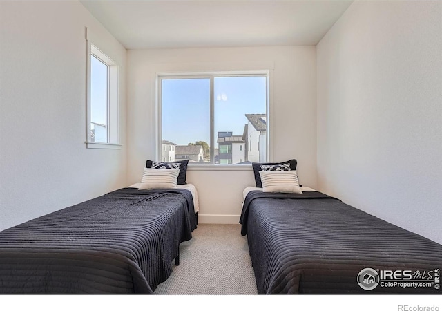 carpeted bedroom featuring multiple windows