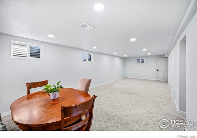 dining space featuring light colored carpet