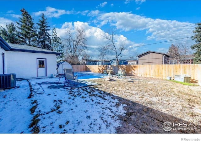 view of yard featuring central AC and a storage shed