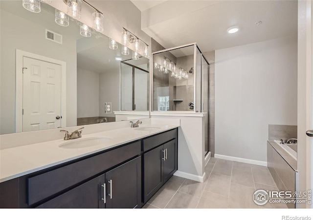 bathroom featuring plus walk in shower, tile patterned flooring, and vanity