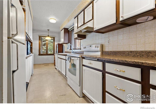 kitchen with white appliances, hanging light fixtures, a textured ceiling, white cabinets, and sink