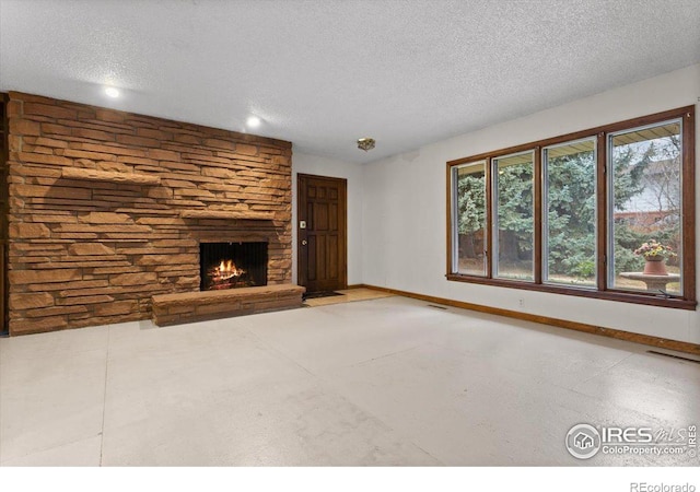 unfurnished living room with a textured ceiling and a fireplace