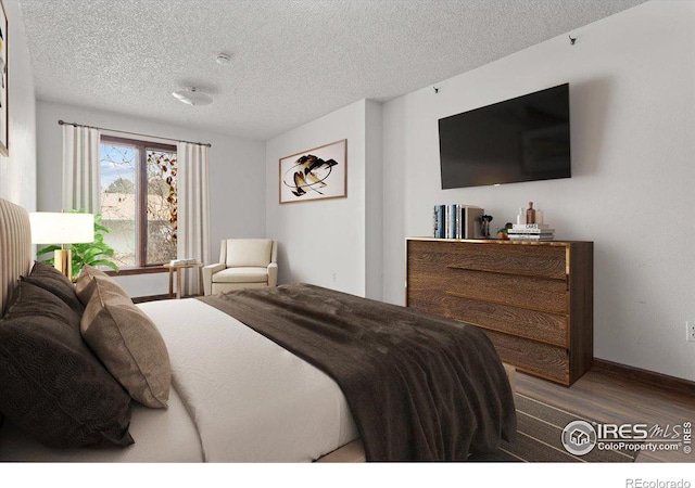 bedroom with a textured ceiling and wood-type flooring