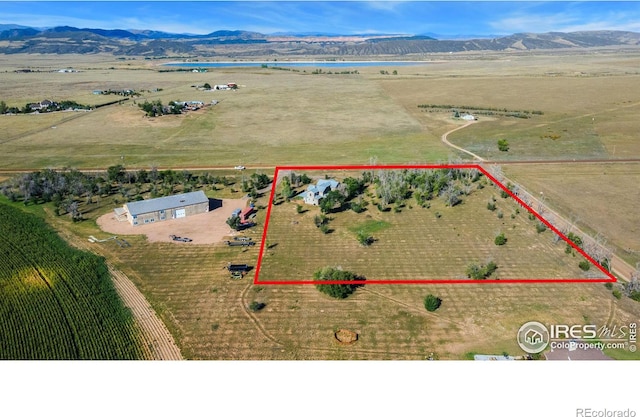 birds eye view of property featuring a mountain view and a rural view