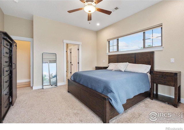 bedroom featuring ceiling fan and light carpet