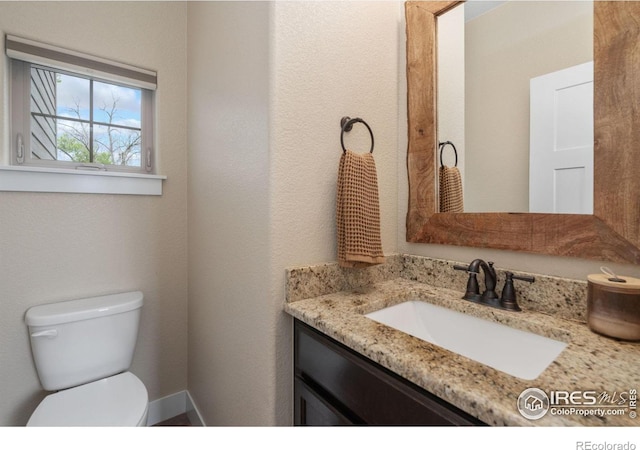 bathroom with toilet and vanity