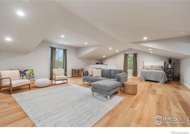 bedroom featuring lofted ceiling and light hardwood / wood-style flooring