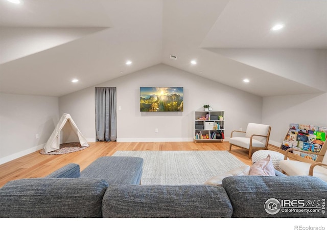 living room featuring vaulted ceiling and hardwood / wood-style floors