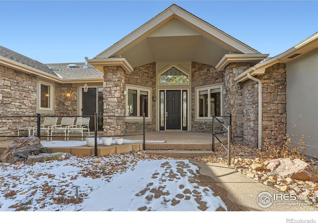 view of snow covered property entrance