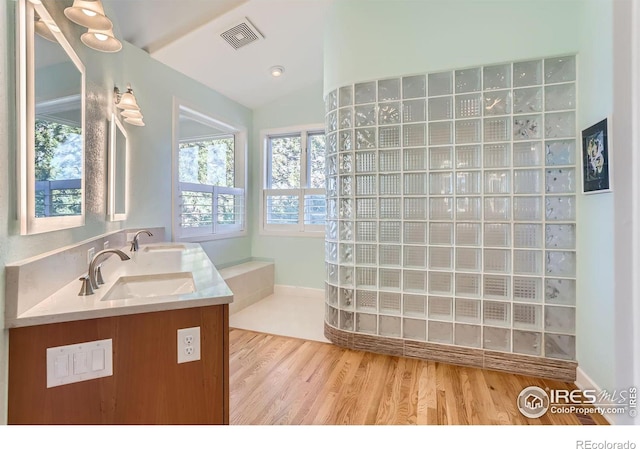 bathroom featuring lofted ceiling, hardwood / wood-style floors, and vanity