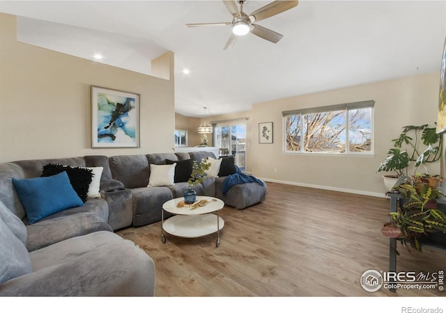 living room featuring lofted ceiling, ceiling fan, and light hardwood / wood-style floors