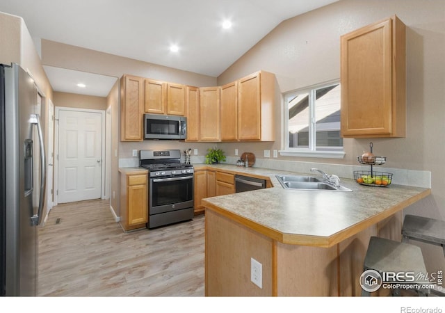 kitchen featuring light brown cabinets, appliances with stainless steel finishes, kitchen peninsula, and sink