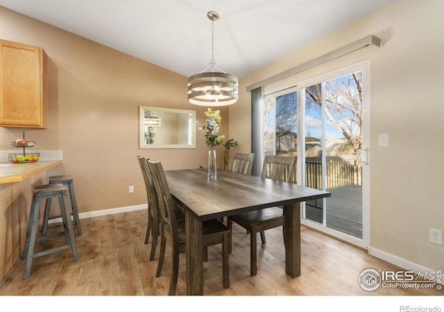 dining room featuring light hardwood / wood-style flooring and a notable chandelier