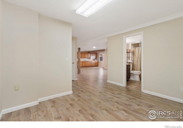 spare room with light hardwood / wood-style floors