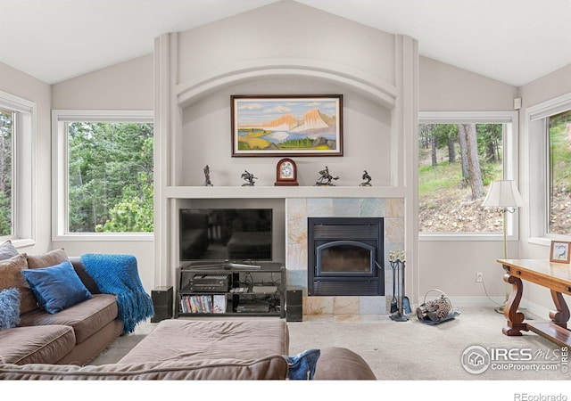 living room with lofted ceiling, carpet floors, and a tile fireplace