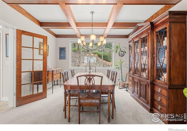 dining area with light carpet, an inviting chandelier, coffered ceiling, and beamed ceiling