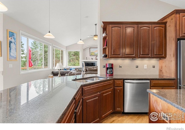 kitchen with appliances with stainless steel finishes, backsplash, lofted ceiling, pendant lighting, and sink