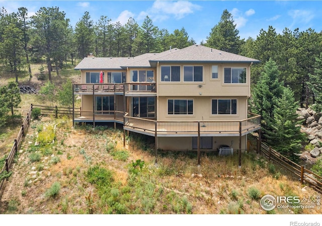 rear view of property featuring a deck