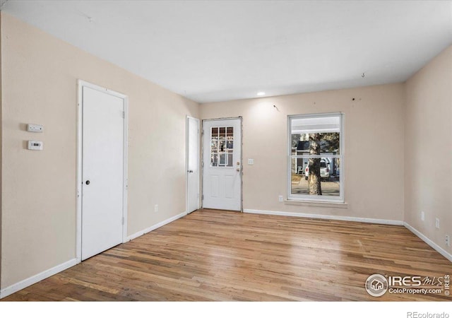 empty room with light hardwood / wood-style floors