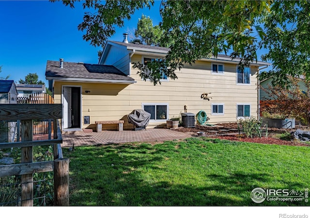 back of house featuring a patio, a yard, and central AC unit