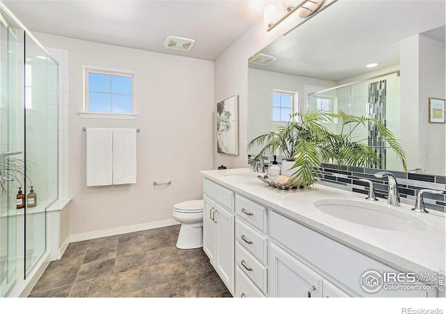 bathroom with backsplash, an enclosed shower, vanity, and toilet