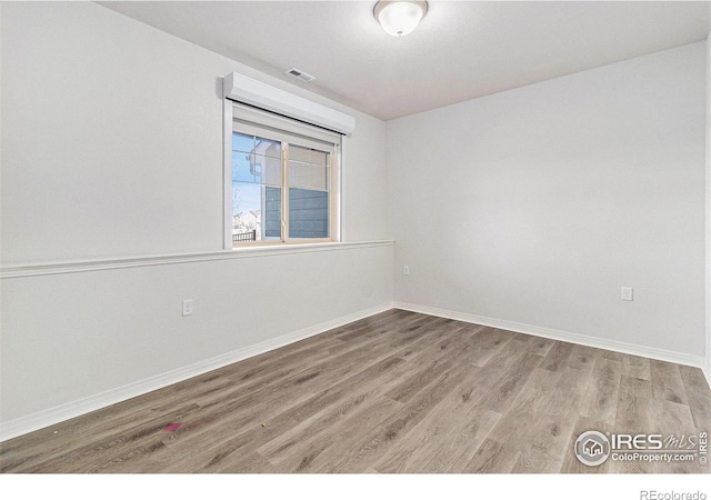 empty room with wood-type flooring