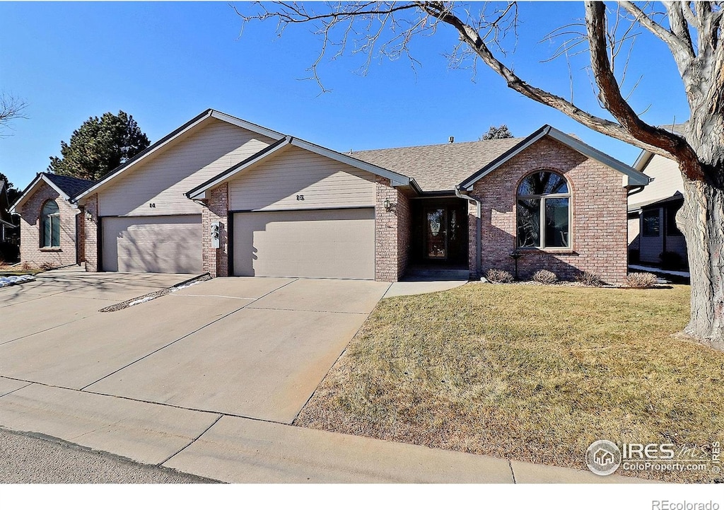 ranch-style home with a front lawn and a garage