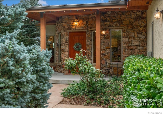 view of exterior entry with covered porch