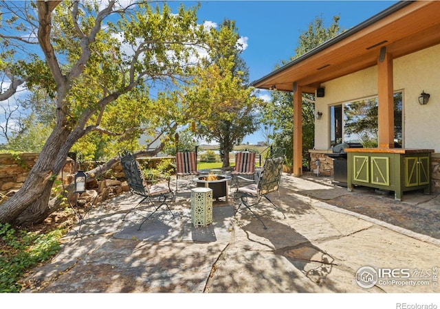 view of patio / terrace featuring a fire pit