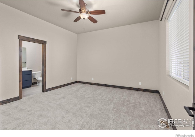 spare room featuring ceiling fan and light carpet