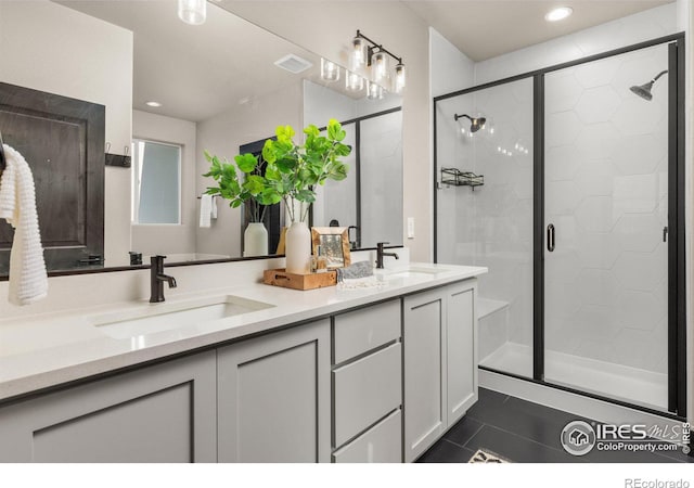 bathroom featuring vanity, tile patterned flooring, and a shower with door