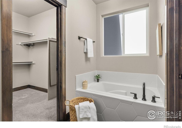 bathroom featuring a relaxing tiled tub