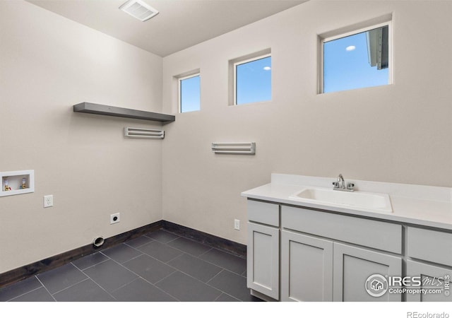 bathroom with tile patterned flooring and vanity