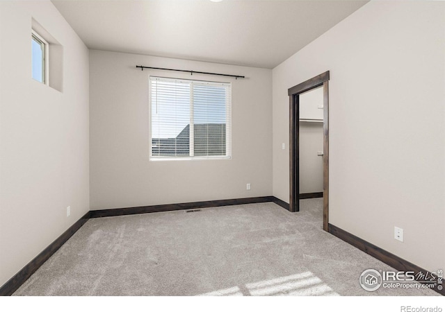 unfurnished bedroom with light carpet