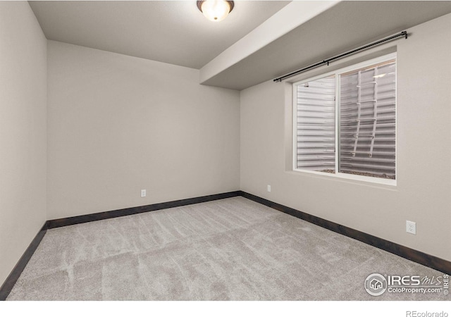 unfurnished room featuring light colored carpet