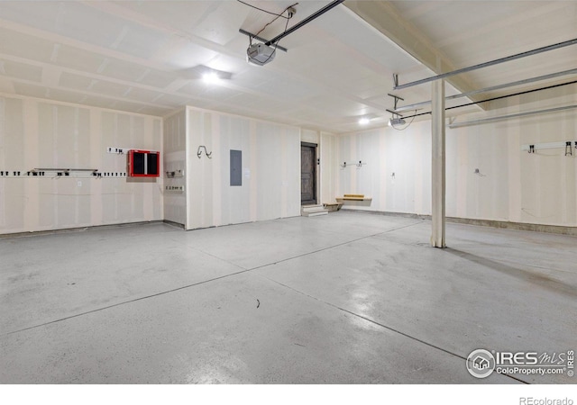 garage featuring a garage door opener and electric panel