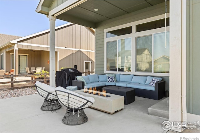 view of patio / terrace featuring area for grilling and an outdoor living space with a fire pit