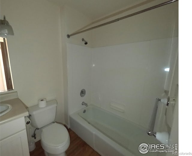 full bathroom featuring toilet, shower / bathtub combination, wood-type flooring, and vanity