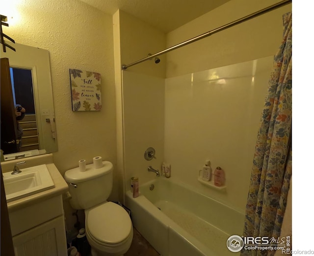 full bathroom with toilet, vanity, and washtub / shower combination